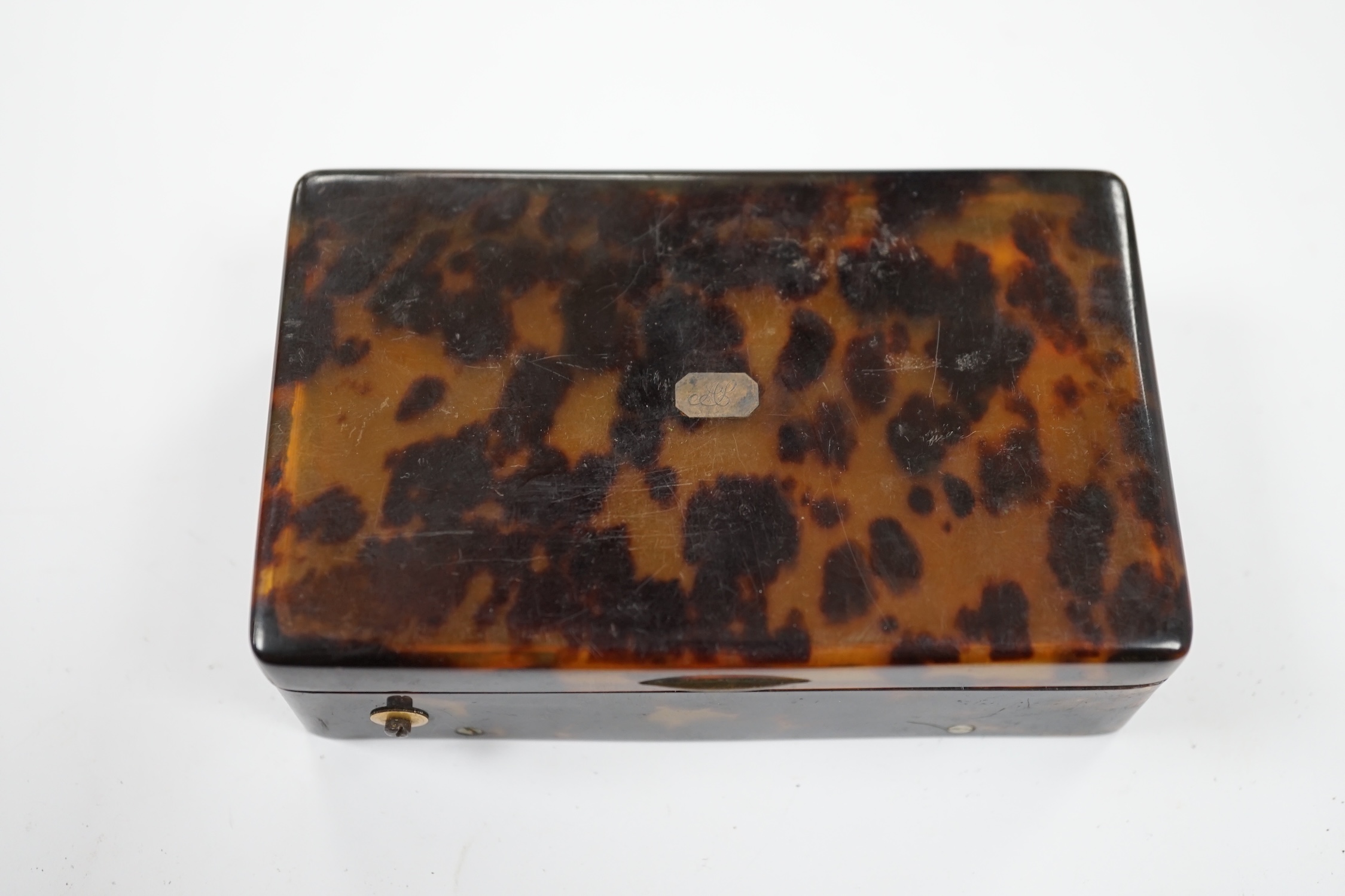 A 19th century tortoiseshell cased musical snuff box, 10cm. Condition - fair